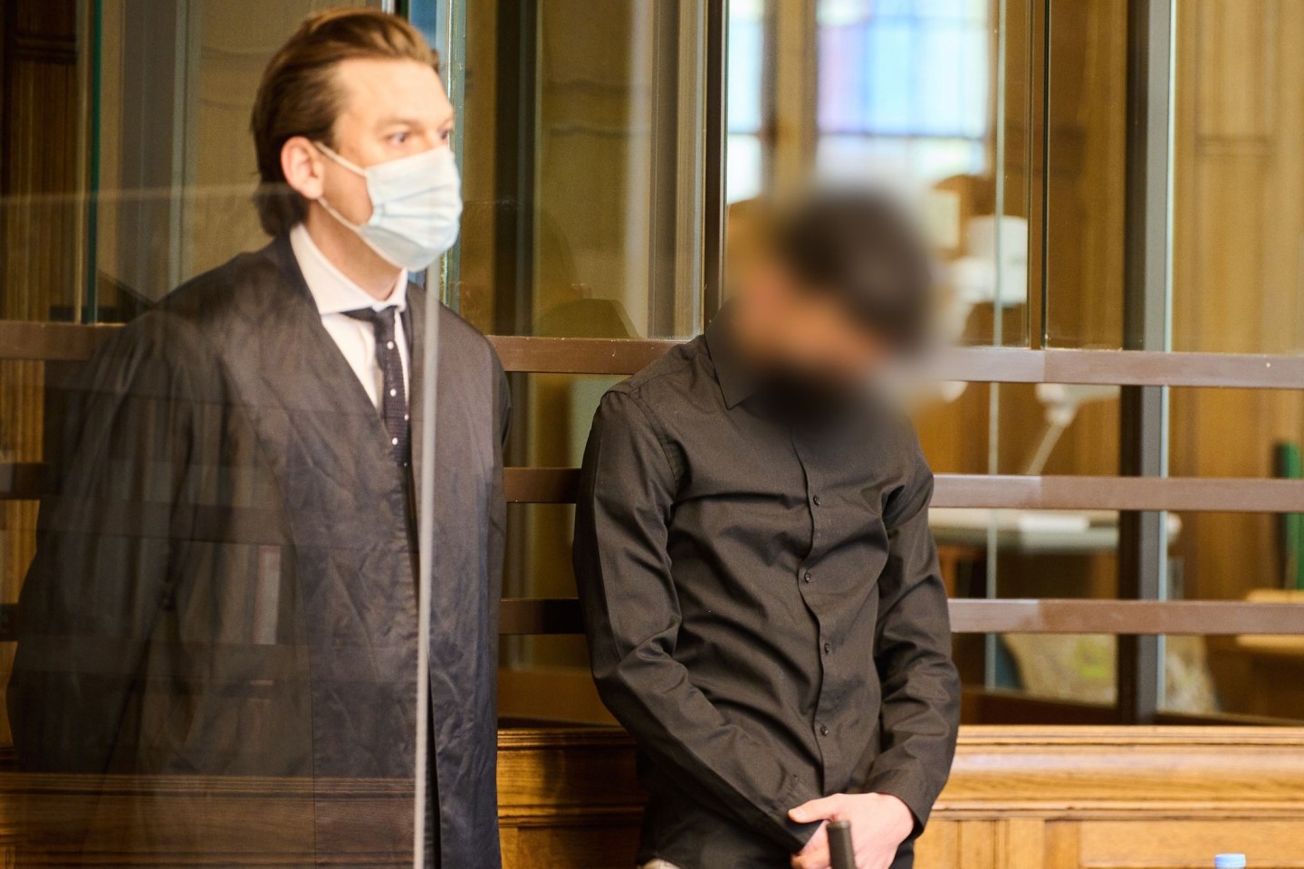 Der 22-jährige Angeklagte (r) steht zum Prozessauftakt neben seinem Anwalt im Landgericht Berlin.