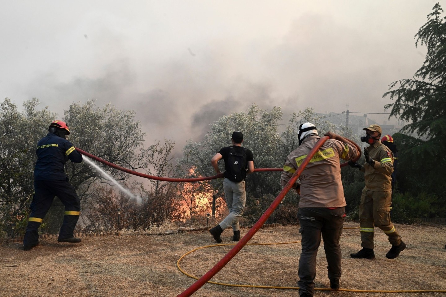 Feuerwehrleute und Freiwillige versuchen, einen Brand bei Nea Anchialos zu löschen.