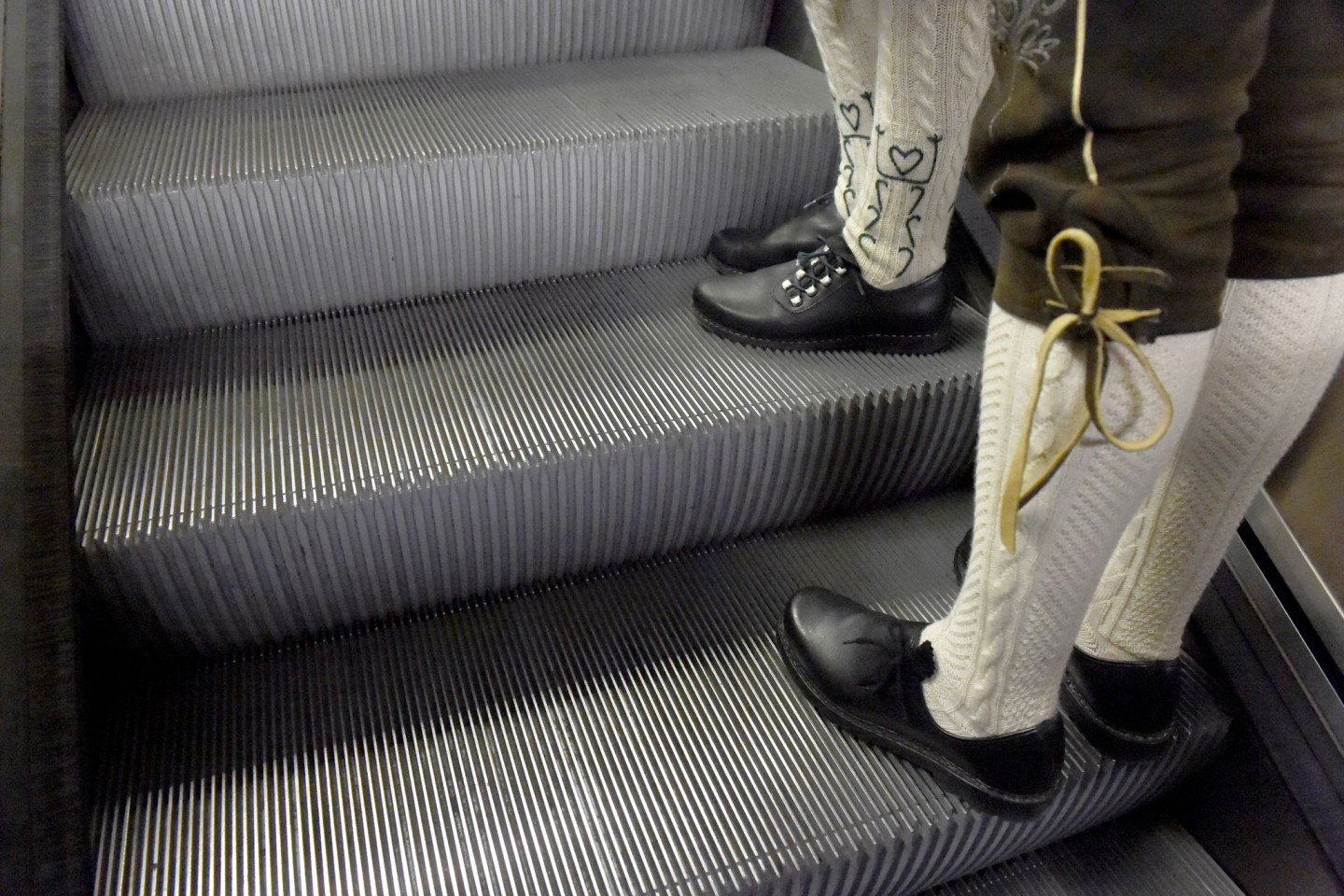 Trachtler stehen auf den Stufen einer Rolltreppe in München, nachdem sie das Oktoberfest verlassen haben.
